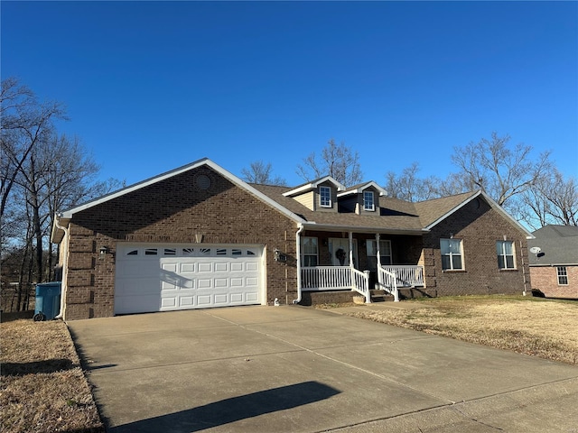 121 Stull Dr, Benton, MO 63736 - view of front of home featuring brick siding, a porch, concrete driveway, and an attached garage