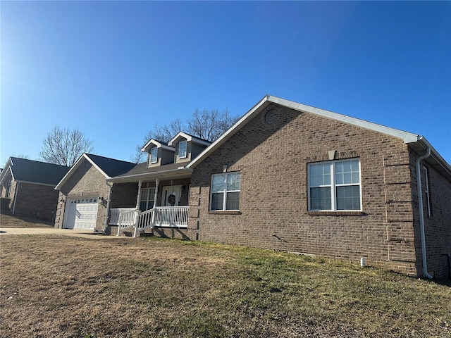 121 Stull Dr, Benton, MO 63736 - view of front of property featuring brick siding, an attached garage, and covered porch