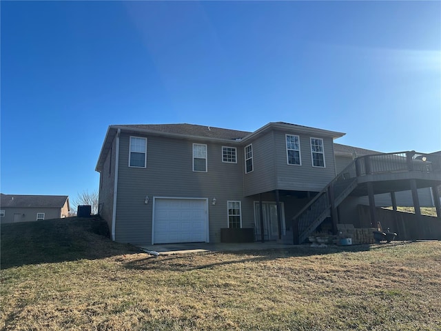 121 Stull Dr, Benton, MO 63736 - rear view of house featuring stairway, a wooden deck, an attached garage, and a lawn
