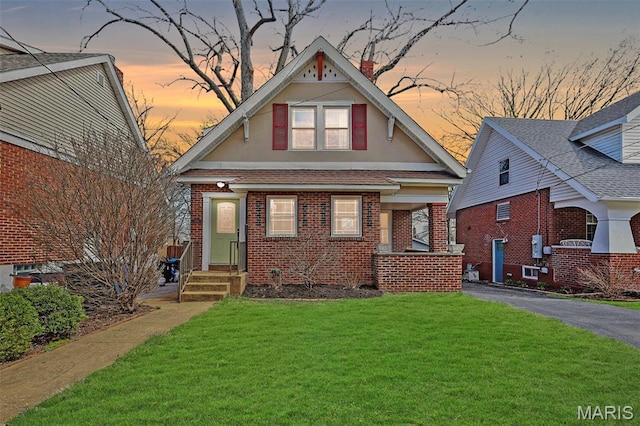 2326 Bellevue Ave, Saint Louis, MO 63143 - view of front facade with stucco siding, brick siding, a front yard, and entry steps