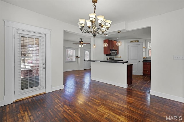 2326 Bellevue Ave, Saint Louis, MO 63143 - kitchen featuring stainless steel appliances, a chandelier, dark countertops, a ceiling fan, and hanging light fixtures