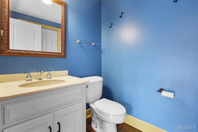 2326 Bellevue Ave, Saint Louis, MO 63143 - bathroom with toilet, vanity, baseboards, and wood finished floors
