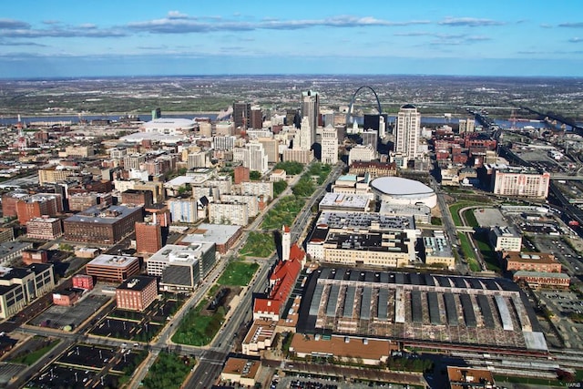 aerial view of property and surrounding area with nearby urban area
