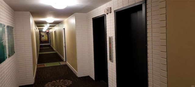 hall with tile patterned floors