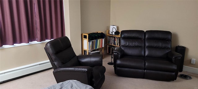 living area featuring a baseboard heating unit, carpet floors, and baseboards