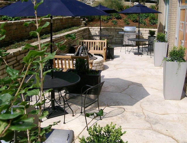 view of patio with outdoor dining area and area for grilling