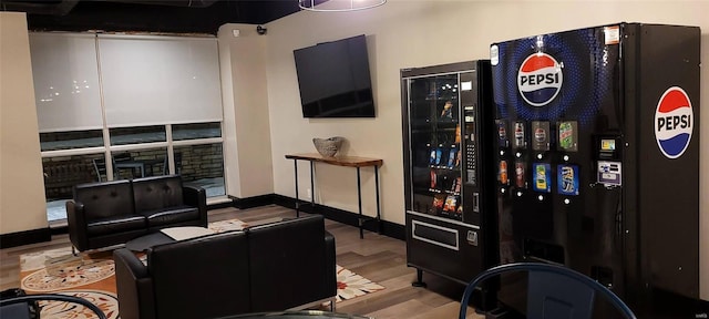home theater with wood finished floors and baseboards
