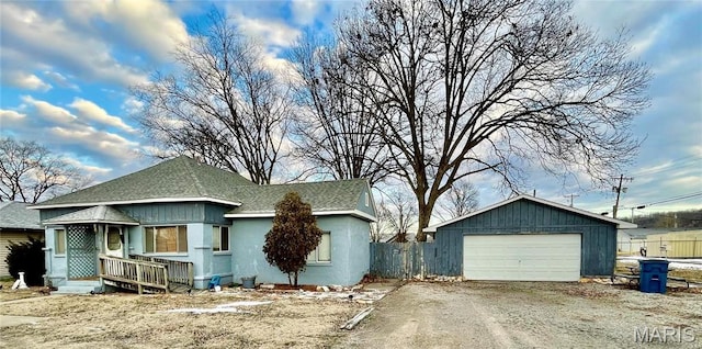 115 Cook Ave, Chaffee, MO 63740 - view of front of house featuring a shingled roof, a garage, an outdoor structure, and stucco siding