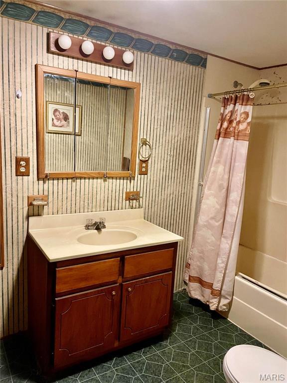 115 Cook Ave, Chaffee, MO 63740 - bathroom with vanity, wallpapered walls, shower / bath combination with curtain, toilet, and tile patterned floors