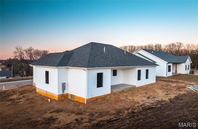 210 Sunny Dr, Rolla, MO 65401 - back of house featuring a shingled roof and a patio