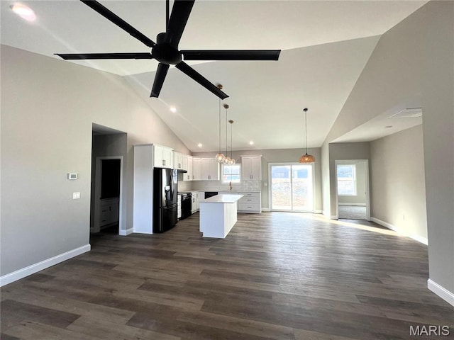 210 Sunny Dr, Rolla, MO 65401 - kitchen featuring black fridge with ice dispenser, open floor plan, a center island, white cabinets, and baseboards