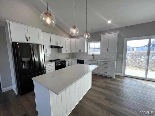 210 Sunny Dr, Rolla, MO 65401 - kitchen with black appliances, a sink, vaulted ceiling, backsplash, and a center island