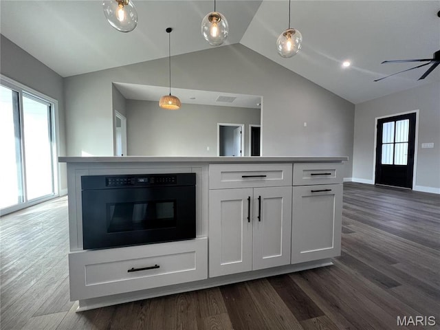 210 Sunny Dr, Rolla, MO 65401 - kitchen featuring lofted ceiling, open floor plan, white cabinetry, dark wood-style flooring, and black oven