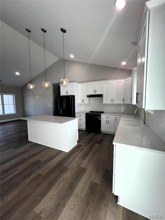 210 Sunny Dr, Rolla, MO 65401 - kitchen featuring black appliances, a sink, vaulted ceiling, a kitchen island, and dark wood-style floors