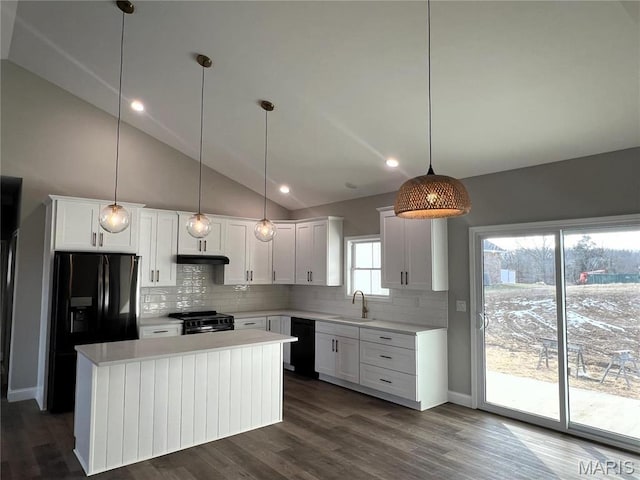 210 Sunny Dr, Rolla, MO 65401 - kitchen with black appliances, tasteful backsplash, light countertops, vaulted ceiling, and white cabinets