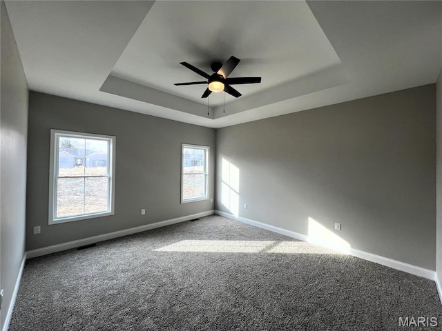 210 Sunny Dr, Rolla, MO 65401 - carpeted spare room featuring a tray ceiling, a ceiling fan, and baseboards
