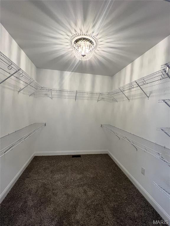 210 Sunny Dr, Rolla, MO 65401 - spacious closet with carpet flooring and a chandelier