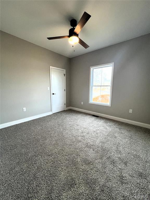210 Sunny Dr, Rolla, MO 65401 - carpeted empty room featuring baseboards and a ceiling fan