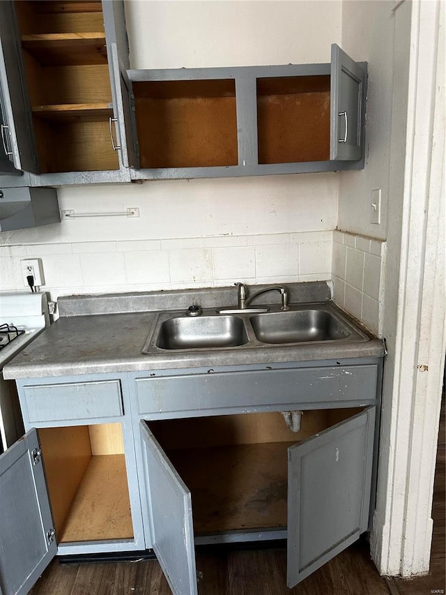 6705 Saint Louis Ave, Saint Louis, MO 63121 - kitchen featuring open shelves, dark wood-type flooring, a sink, and decorative backsplash