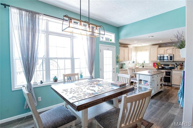 10415 Summerfield Dr, Rolla, MO 65401 - dining area featuring a textured ceiling, dark wood-style flooring, a chandelier, and baseboards