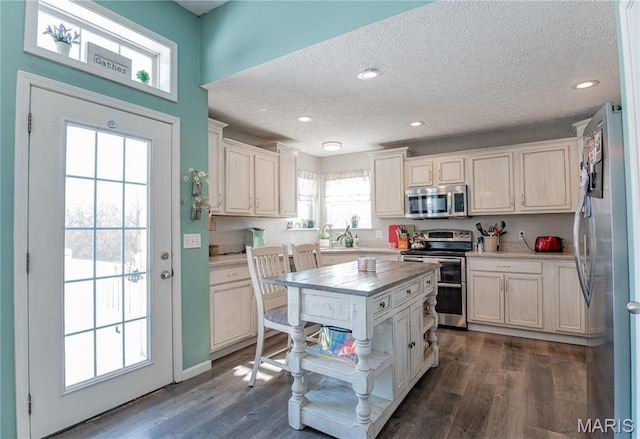 10415 Summerfield Dr, Rolla, MO 65401 - kitchen with appliances with stainless steel finishes, a textured ceiling, dark wood-style flooring, light countertops, and white cabinetry
