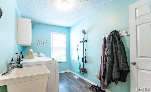 10415 Summerfield Dr, Rolla, MO 65401 - laundry area with washing machine and dryer, cabinet space, wood finished floors, a textured ceiling, and baseboards