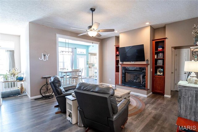 10415 Summerfield Dr, Rolla, MO 65401 - living area with ceiling fan, dark wood-type flooring, a textured ceiling, a high end fireplace, and plenty of natural light