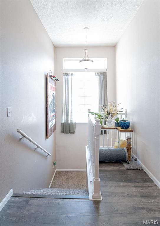 10415 Summerfield Dr, Rolla, MO 65401 - stairway featuring wood finished floors, baseboards, and a textured ceiling