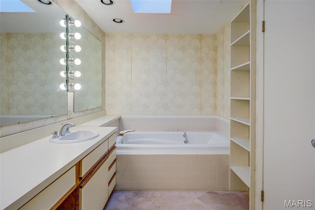 full bathroom featuring wallpapered walls, a skylight, vanity, and a bath