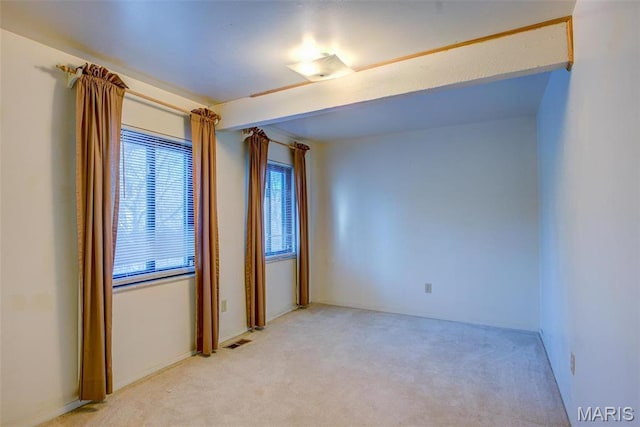 unfurnished room with light colored carpet
