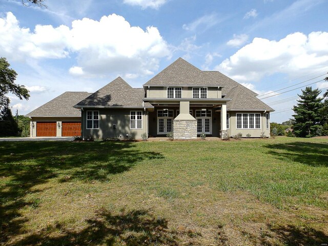 267 Saint Andrews Dr, Saint Albans, MO 63073 - view of front of house featuring french doors, a front yard, a garage, stucco siding, and roof with shingles