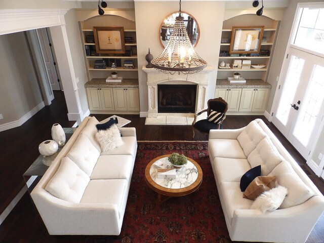 267 Saint Andrews Dr, Saint Albans, MO 63073 - living area with a high end fireplace, dark wood-style floors, a chandelier, and baseboards