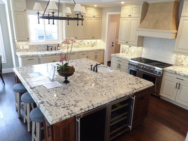 267 Saint Andrews Dr, Saint Albans, MO 63073 - kitchen featuring range with two ovens, a sink, premium range hood, dark wood finished floors, and light stone countertops