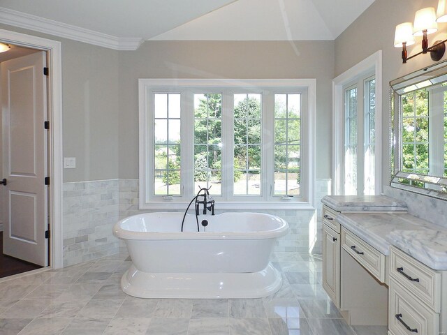 267 Saint Andrews Dr, Saint Albans, MO 63073 - bathroom featuring tile walls, a freestanding tub, vanity, a wainscoted wall, and crown molding