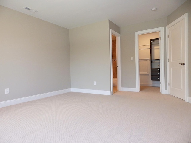 267 Saint Andrews Dr, Saint Albans, MO 63073 - unfurnished bedroom with a spacious closet, light carpet, a closet, and baseboards
