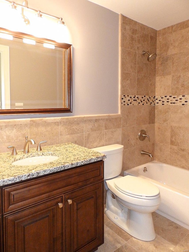 267 Saint Andrews Dr, Saint Albans, MO 63073 - bathroom featuring tile walls, toilet, vanity, washtub / shower combination, and tile patterned flooring