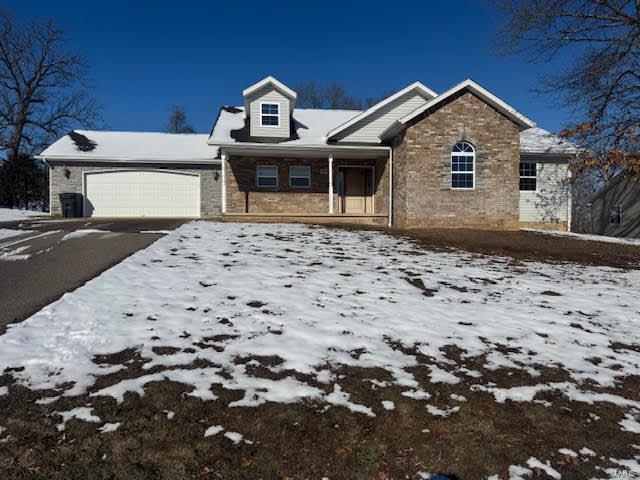 18882 Ladera Rd, Waynesville, MO 65583 - view of front of home with a garage, stone siding, driveway, and a porch