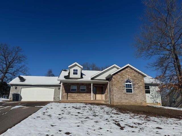 18882 Ladera Rd, Waynesville, MO 65583 - view of front of home featuring a garage, asphalt driveway, and brick siding