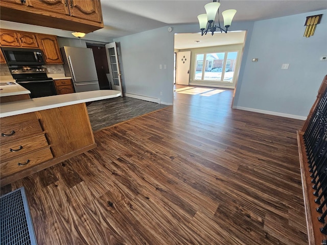 111 Linn Dr, Saint Genevieve, MO 63670 - kitchen with freestanding refrigerator, brown cabinetry, black electric range, open floor plan, and light countertops
