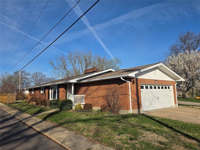 111 Linn Dr, Saint Genevieve, MO 63670 - view of front of home featuring brick siding, a garage, a front yard, and concrete driveway