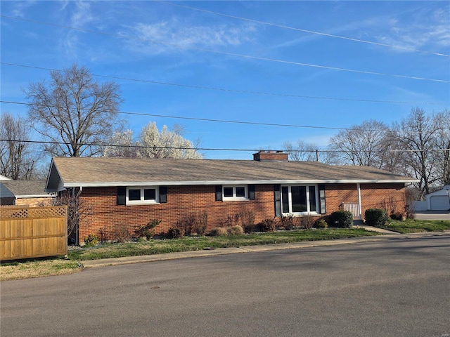 111 Linn Dr, Saint Genevieve, MO 63670 - single story home featuring brick siding, a chimney, fence, and roof with shingles