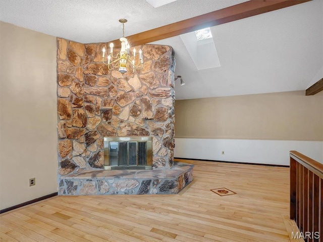 3553 Evergreen Dr, Catawissa, MO 63015 - unfurnished living room with a skylight, a chandelier, wood finished floors, lofted ceiling, and baseboards