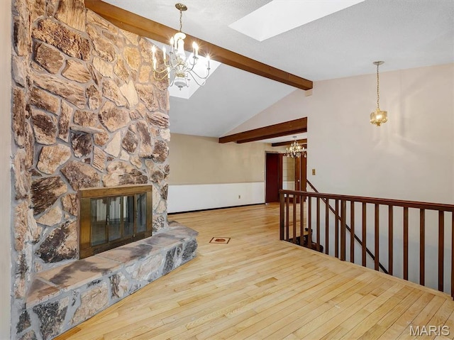 3553 Evergreen Dr, Catawissa, MO 63015 - living area with a chandelier, wood-type flooring, a skylight, and a stone fireplace
