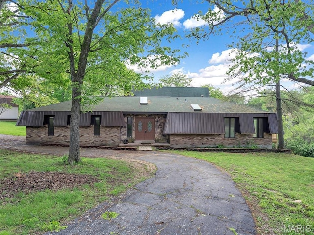 3553 Evergreen Dr, Catawissa, MO 63015 - view of front of house with brick siding, asphalt driveway, and a front yard