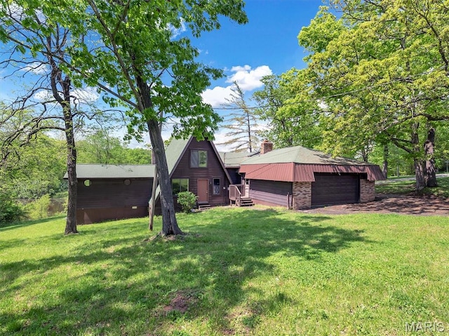 3553 Evergreen Dr, Catawissa, MO 63015 - rear view of property featuring a chimney, a lawn, and a garage
