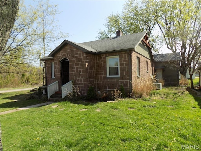 170 County Rd, Ironton, MO 63650 - view of front of home with a chimney, roof with shingles, a front yard, and central air condition unit