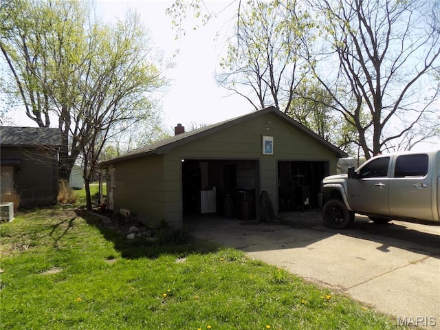 170 County Rd, Ironton, MO 63650 - view of side of property with a detached garage, a chimney, and a lawn