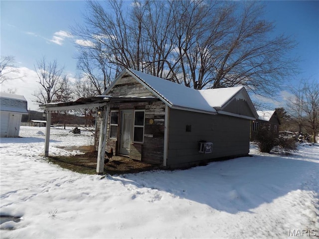 170 County Rd, Ironton, MO 63650 - snow covered property with stone siding and an outbuilding