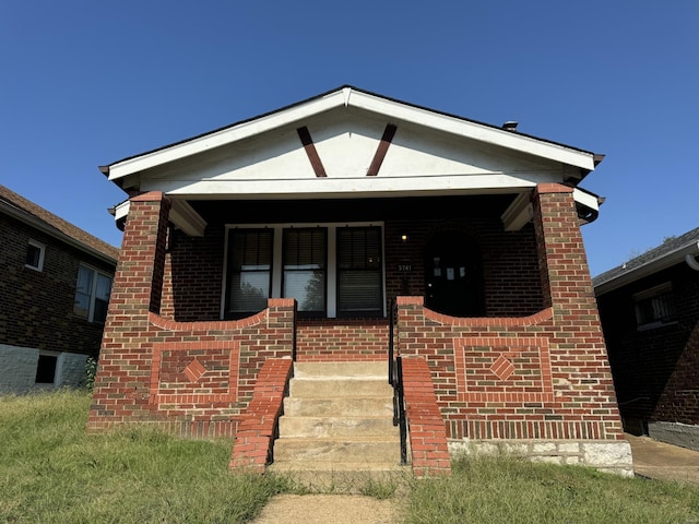 5741 Floy Ave, Saint Louis, MO 63136 - view of front of house featuring brick siding and a porch
