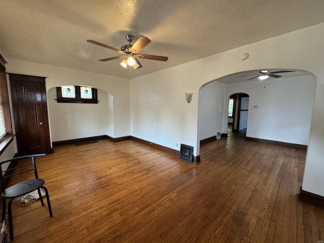5741 Floy Ave, Saint Louis, MO 63136 - unfurnished room featuring a ceiling fan, arched walkways, wood-type flooring, healthy amount of natural light, and a textured ceiling